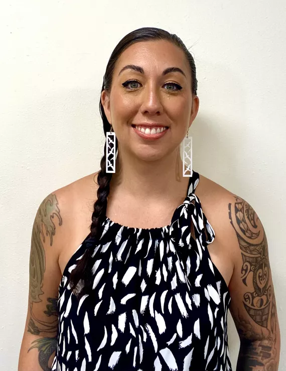 Black and white top, tattoos.