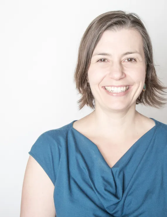 Smiling white woman with brown hair and eyes