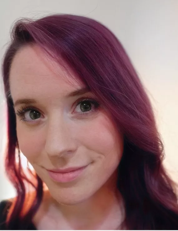 young white woman with magenta hair and green eyes