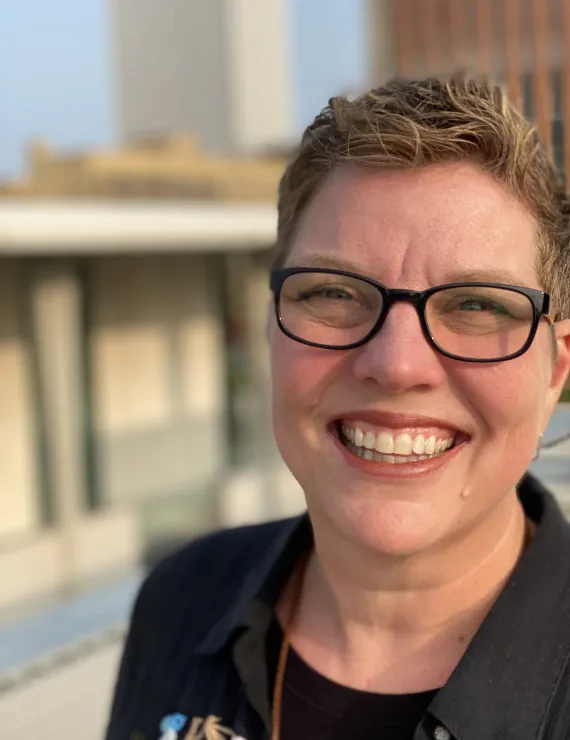 Short light brown haired 53 year old cisgender white female with glasses
