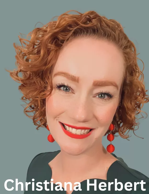 a headshot of Christiana Herbert, a white woman with red hair and a big smile