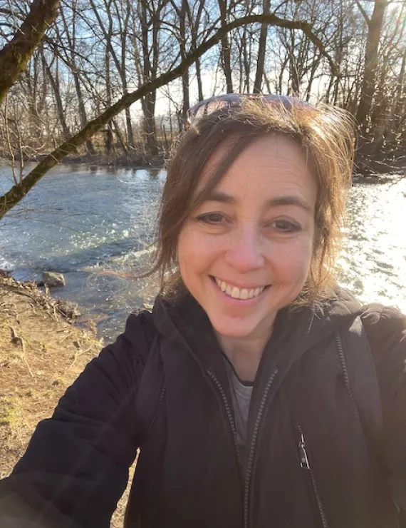 A photo of Rivkah hiking on a beautiful day.