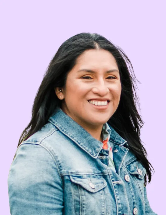 Womxn of color, black hair, brown eyes, denim jacket, lavender background