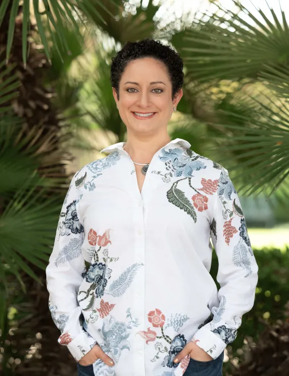 Dr. Ansbro headshot outside in front of palm trees