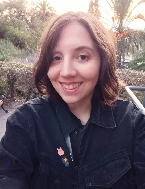Photo of 34-year old woman smiling with trees in the background